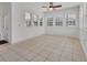 Sunroom with white walls, ceiling fan and tile floors at 955 N Ridgewood Ave, Deland, FL 32720