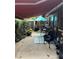 Cozy back patio with awning, seating, and plants at 115 Cypress Pond Rd, Port Orange, FL 32128