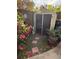 Backyard with shed, flowers, and stone pathway at 115 Cypress Pond Rd, Port Orange, FL 32128