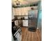 Well-lit kitchen featuring stainless steel appliances and beautiful wood flooring at 115 Cypress Pond Rd, Port Orange, FL 32128