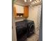 Well-equipped laundry room with washer, dryer, and cabinets at 115 Cypress Pond Rd, Port Orange, FL 32128