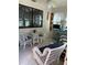 Sunroom with wicker furniture and a view of the garden at 115 Cypress Pond Rd, Port Orange, FL 32128