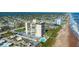 Oceanfront building with pool, coastal road, and town view at 1513 Ocean Shore Blvd # 2B, Ormond Beach, FL 32176