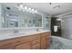 Double vanity bathroom with light wood cabinets and a shower/tub combo at 1513 Ocean Shore Blvd # 2B, Ormond Beach, FL 32176