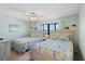 Guest bedroom with two twin beds and ocean view at 1513 Ocean Shore Blvd # 2B, Ormond Beach, FL 32176