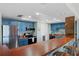 Modern kitchen with blue cabinets, wood countertops, and stainless steel appliances at 1513 Ocean Shore Blvd # 2B, Ormond Beach, FL 32176