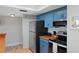 Modern kitchen with blue cabinets, stainless steel appliances, and wood countertops at 1513 Ocean Shore Blvd # 2B, Ormond Beach, FL 32176