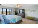 Main bedroom with large bed, dresser, and ocean view at 1513 Ocean Shore Blvd # 2B, Ormond Beach, FL 32176