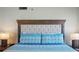 King size bed with headboard and patterned bedding at 1513 Ocean Shore Blvd # 2B, Ormond Beach, FL 32176