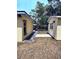 Backyard with outdoor dining set and patio furniture between house and shed at 1649 W Waycross Cir, Deltona, FL 32725