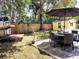 Backyard with outdoor dining and lounging furniture under the shade of mature trees at 1649 W Waycross Cir, Deltona, FL 32725