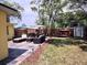 Backyard patio boasts an outdoor seating area, grill, and lounging swing, perfect for enjoying the outdoors at 1649 W Waycross Cir, Deltona, FL 32725