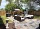 Backyard patio with outdoor furniture, umbrella, and a view of the wooden fence at 1649 W Waycross Cir, Deltona, FL 32725
