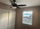 Bedroom featuring a window, ceiling fan, and closet with sliding doors at 1649 W Waycross Cir, Deltona, FL 32725