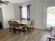 Bright dining room featuring a light-colored table, chairs, and natural light from the large window at 1649 W Waycross Cir, Deltona, FL 32725