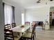 Bright dining room featuring a light-colored table, chairs, and natural light from the large window at 1649 W Waycross Cir, Deltona, FL 32725