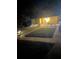 Inviting front yard illuminated with charming landscaping and outdoor seating at night at 1649 W Waycross Cir, Deltona, FL 32725