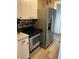 Modern kitchen with stainless steel appliances and white cabinets at 1649 W Waycross Cir, Deltona, FL 32725