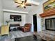 Living room boasts a stone fireplace, ceiling fan, and ample seating with a neutral color palette at 1649 W Waycross Cir, Deltona, FL 32725