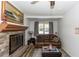 Cozy living room with stone fireplace, brown leather couch, and neutral decor at 1649 W Waycross Cir, Deltona, FL 32725