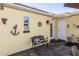 Cozy outdoor patio with bench seating, decorative nautical details, and convenient access to the home's entrances at 1649 W Waycross Cir, Deltona, FL 32725