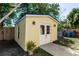 Charming shed with double doors, sconce lights and a lush potted plant at 1649 W Waycross Cir, Deltona, FL 32725