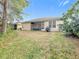 Large backyard with screened porch and plenty of green space at 189 Perfect Dr, Daytona Beach, FL 32124