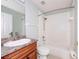 Full bathroom with tub shower combo, wood vanity, and a matching countertop and backsplash at 189 Perfect Dr, Daytona Beach, FL 32124