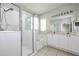 Bright bathroom featuring a glass enclosed shower, soaking tub, and a double sink vanity with white cabinets at 189 Perfect Dr, Daytona Beach, FL 32124