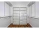 Spacious walk-in closet with custom shelving and wood floors, offering ample storage space at 189 Perfect Dr, Daytona Beach, FL 32124