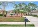 House exterior with palm trees, a driveway, and a mailbox at 189 Perfect Dr, Daytona Beach, FL 32124