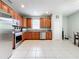 Kitchen with wood cabinets, stainless steel appliances, and tile flooring at 189 Perfect Dr, Daytona Beach, FL 32124
