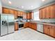 Kitchen with wood cabinets, stainless steel appliances, and tile flooring at 189 Perfect Dr, Daytona Beach, FL 32124