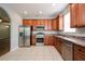 Well-equipped kitchen with stainless steel appliances, granite countertops, and ample wood cabinetry at 189 Perfect Dr, Daytona Beach, FL 32124
