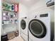 Laundry room with washer, dryer, and shelving at 189 Perfect Dr, Daytona Beach, FL 32124