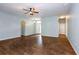 Spacious living room featuring tile floors, a ceiling fan, and an arched doorway at 189 Perfect Dr, Daytona Beach, FL 32124