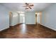 Open-concept living area featuring wood-look tile floors, neutral paint, and an elegant ceiling fan at 189 Perfect Dr, Daytona Beach, FL 32124
