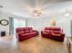 Spacious living room with red leather couches and tile floors at 189 Perfect Dr, Daytona Beach, FL 32124