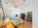 Bright main bedroom featuring a king-size bed, built-in shelving, and tile floors at 189 Perfect Dr, Daytona Beach, FL 32124