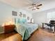 Large main bedroom with a teal and white bedspread, and an adjacent home office at 189 Perfect Dr, Daytona Beach, FL 32124