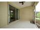 Screened patio with tile flooring, sliding glass doors, and a ceiling fan at 189 Perfect Dr, Daytona Beach, FL 32124