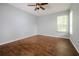Empty room with wood-look tile flooring, neutral paint and natural light from windows at 189 Perfect Dr, Daytona Beach, FL 32124