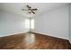 Open room with wood-look tile flooring, ceiling fan and natural light from bright windows at 189 Perfect Dr, Daytona Beach, FL 32124