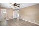 Bedroom with wood-look floors and access to bathroom at 1911 S Palomar Dr, Deltona, FL 32738