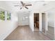 Bright bedroom featuring wood-look floors and mirrored closet doors at 1911 S Palomar Dr, Deltona, FL 32738