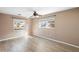 Bright bedroom with wood-look floors and dual windows at 1911 S Palomar Dr, Deltona, FL 32738