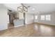 Open living room features wood-look floors and kitchen bar at 1911 S Palomar Dr, Deltona, FL 32738