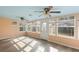 Sunroom addition with light walls, wood floors and ceiling fans at 1911 S Palomar Dr, Deltona, FL 32738