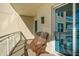 Relaxing balcony with wooden chairs and building view at 1925 S Atlantic Ave # 706, Daytona Beach, FL 32118
