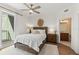 Bright bedroom with a wicker bed frame and en-suite bathroom at 1925 S Atlantic Ave # 706, Daytona Beach, FL 32118